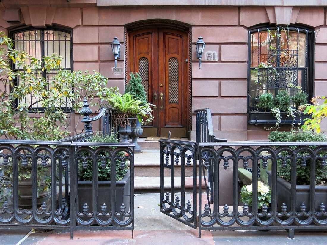 A tree-lined street of brownstones in Greenwich Village